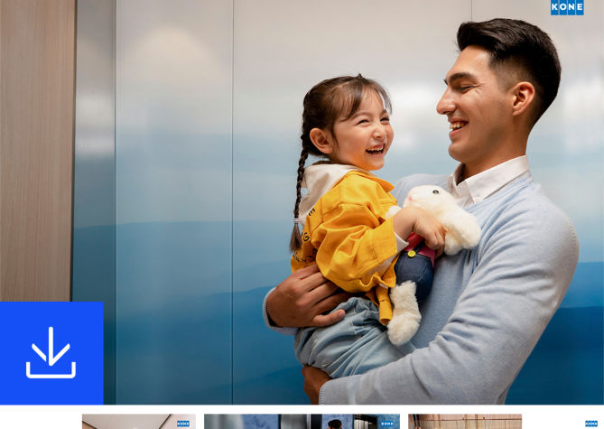 Father carrying daughter in front of an elevator - KONE Modernization handbook.